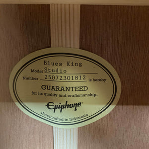 An oval label inside the Epiphone Blues King Studio Dark Burst reads: "Number 25072301812 is GUARANTEED for quality and craftsmanship. Epiphone. Handcrafted in Indonesia.