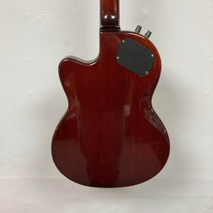 The back of an Epiphone Chet Atkins SST Studio Natural Korea guitar is displayed against a white background, showcasing its glossy wood finish and black cover plate with visible screws. This used consignment includes a hard case.