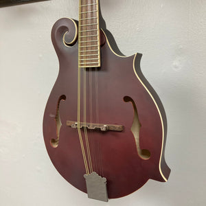 Epiphone F-5 Studio Mandolin in Wine Red Satin, showcasing its detailed strings and classic F-style design. Perfect for musicians at every stage.