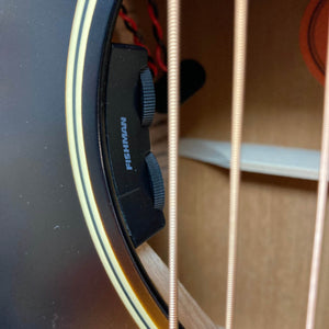 Close-up of the Epiphone L-00 Standard Vintage Sunburst w/Gigbag by Epiphone, showing Fishman control knobs and three steel strings on this small-bodied acoustic guitar.