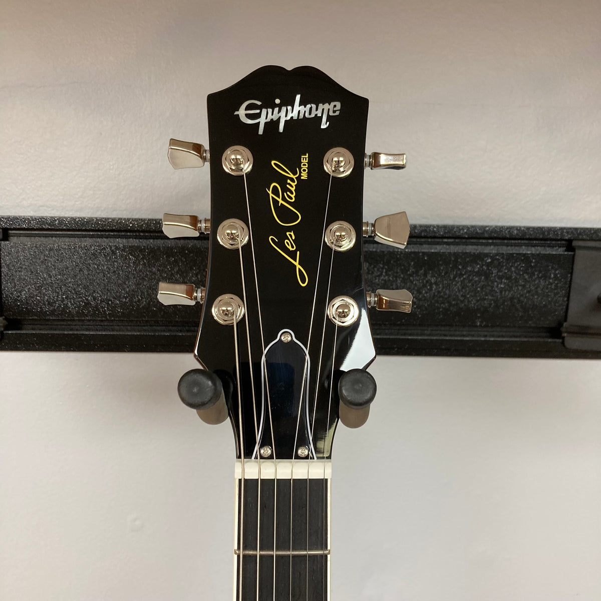 Epiphone Les Paul Modern Figured Magma Orange Fade on stand, featuring a maple top, mahogany body, and ProBucker pickups with coil-splitting and phase-switching capabilities.