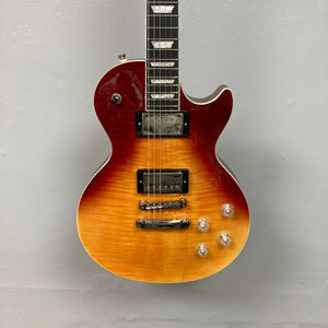 Epiphone Les Paul Modern Figured Magma Orange Fade guitar, close-up of strings and body, showcasing maple top and mahogany construction.