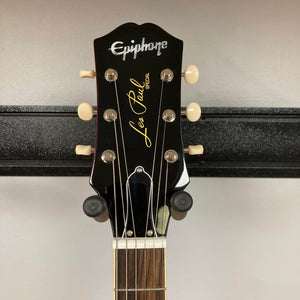 Close-up of the Epiphone Les Paul Special Double Cut Cherry Red w/Gigbag headstock, featuring tuning pegs and the Epiphone logo.