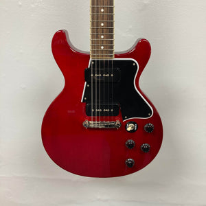 An Epiphone Les Paul Special Double Cut Cherry Red electric guitar with gigbag, featuring dual pickups, four control knobs, black pickguard, by Epiphone. Set against a plain light background.