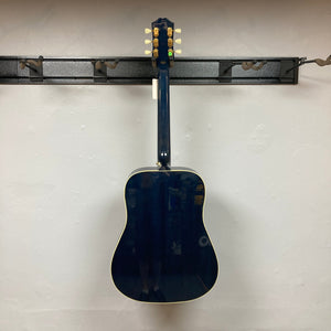 Epiphone Miranda Lambert Bluebird Studio - Bluebonnet guitar displayed on a wall, highlighting its elegant design and craftsmanship.