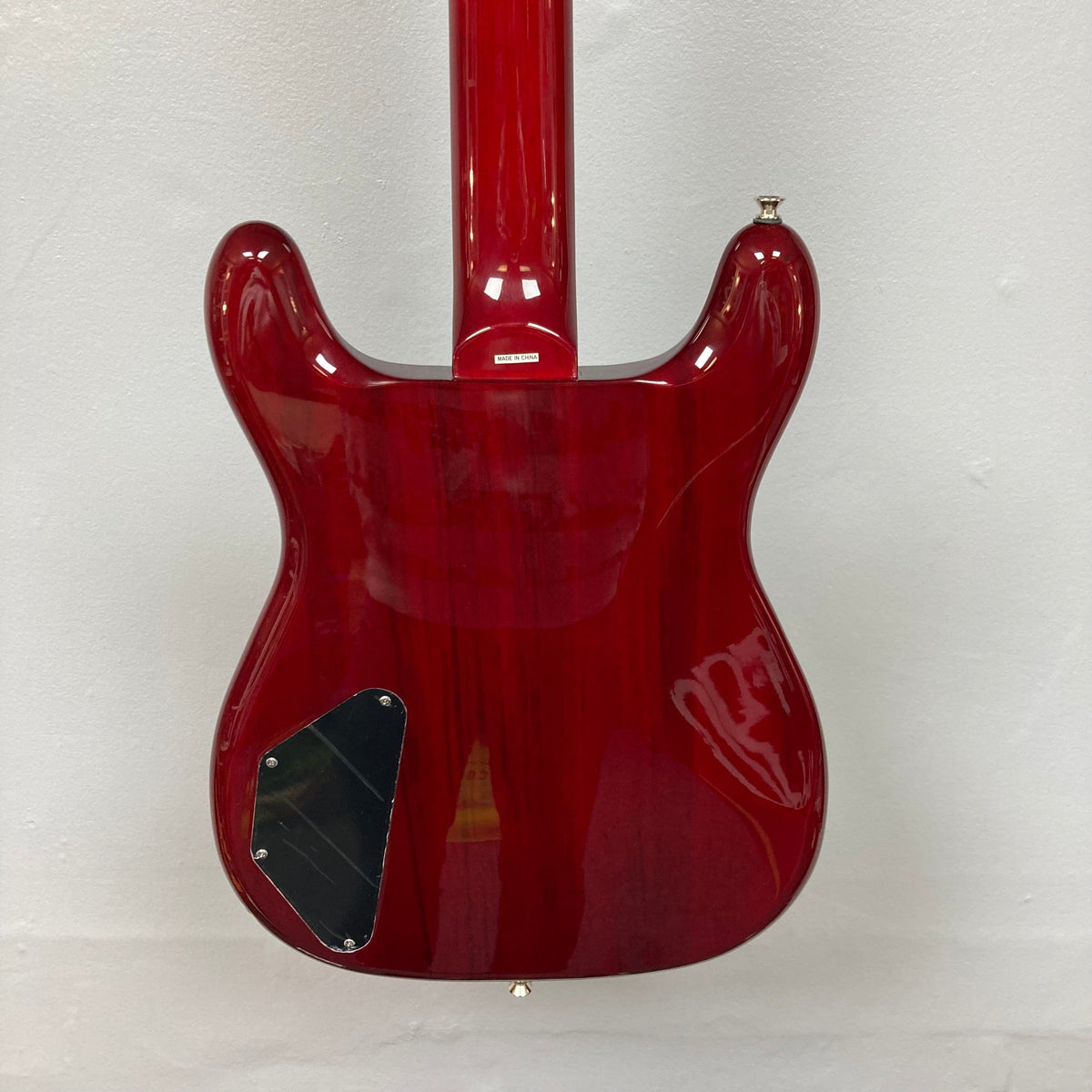 Epiphone Newport Bass Cherry electric guitar with mahogany body and neck, featuring medium jumbo frets, humbuckers, and control knobs for volume, tone, and blend.