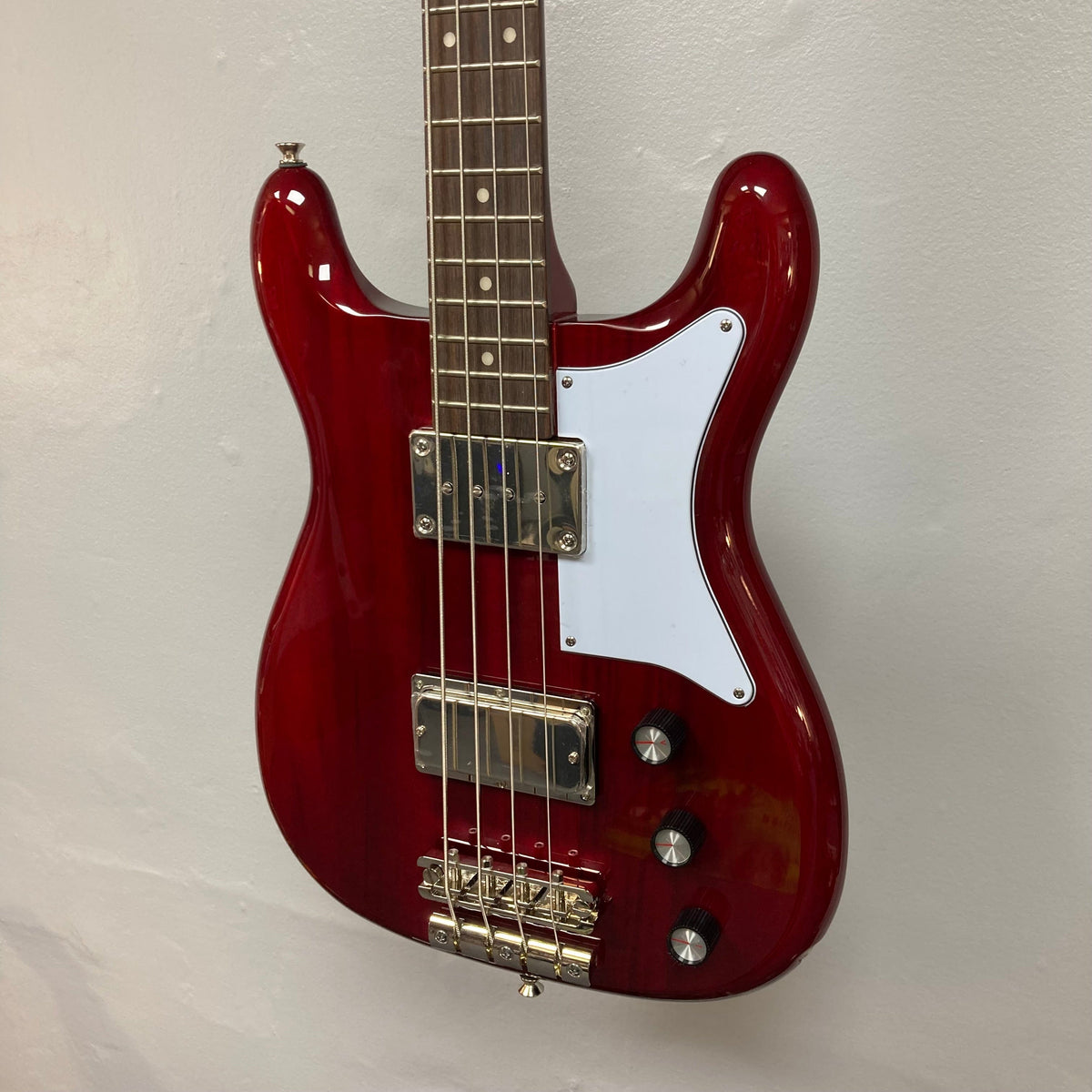 Epiphone Newport Bass Cherry, 4-string electric guitar with a distinctive vintage body shape, mahogany construction, and dual humbuckers for rich, dynamic sound.