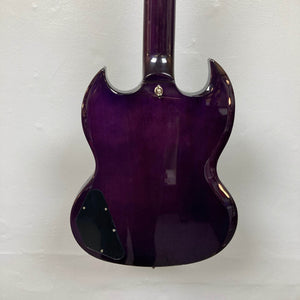 A close-up of the Epiphone SG Modern Figured Purple Burst w/GigBag electric guitar shows its glossy purple finish, two pointed horns, and black control cavity cover, all set against a plain white wall.
