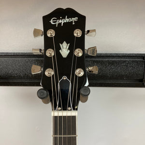 Epiphone SG Modern Figured guitar head on a stand, showcasing the neck and detailed hardware, including Grover® Locking Rotomatic® tuners.