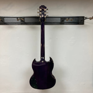 Epiphone SG Modern Figured Purple Burst electric guitar, mahogany body, AAA maple veneer, ProBucker humbucker pickups, displayed on a wall with a premium gig bag.