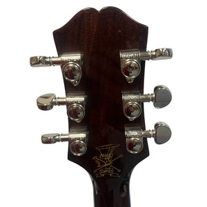Close-up of the back of the Epiphone Slash J-45 Acoustic Guitar w/Case headstock, highlighting six chrome tuning pegs and a gold logo detail.
