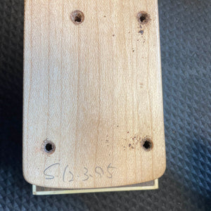 A close-up of the ESP Standard Eclipse Transparent Cherry Red guitar body by Esp, showing four drilled holes and "CL 395" handwritten at the bottom, set against a textured dark background.