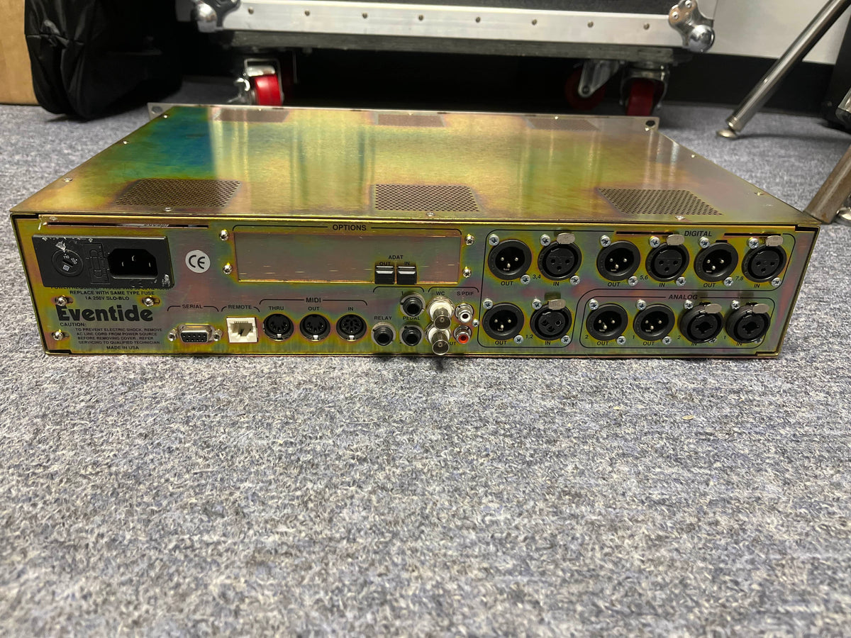 Rear view of a preowned Eventide H8000 Multi-Channel Effects System by Eventide, displaying XLR, MIDI, and power connectors on a carpeted floor.