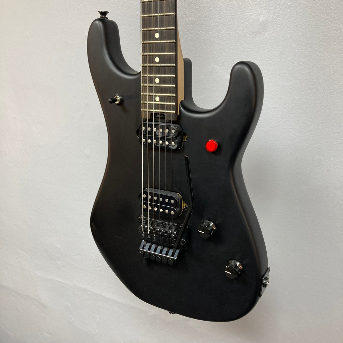 Black EVH 5150 Standard electric guitar on display, featuring close-up details of strings and knobs. Used condition, available at Guitars on Main.