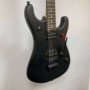 EVH 5150 Standard Stealth Black Used electric guitar mounted on a wall, highlighting its strings and neck details.