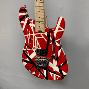 EVH Striped Series guitar with red, black, and white stripes, highlighting the neck and strings, available at Guitars on Main.