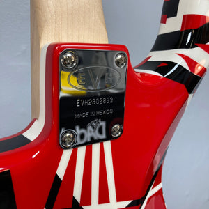 Close-up of an EVH Striped Series guitar, featuring intricate metal elements and distinctive red, black, and white stripe pattern.