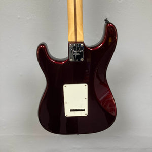 Back view of a Bordeaux Metallic Fender American Standard Strat upgraded Gilmour EMG DC-20 electric guitar (used) against a light gray wall, showing the neck joint, back plate, and no strings attached.