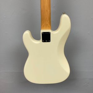 Back view of a 2005 Fender American Vintage '62 Precision Bass in Olympic White with natural wood neck, set against a plain gray wall. Includes case.