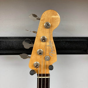 Close-up of a Fender American Vintage '62 Precision Bass Olympic White 2005 headstock, showing four tuning pegs, with a plain wall background.