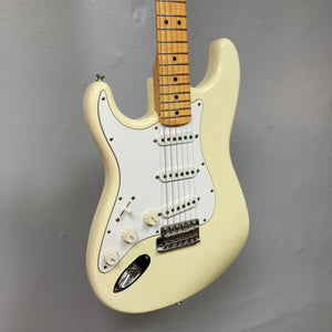 Fender Artist Series Jimi Hendrix Tribute Stratocaster USA 1997 w/Case, pristine white electric guitar displayed on a wall, featuring original knobs and Hendrix-style straps.