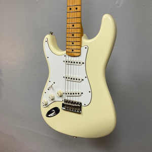 Fender Artist Series Jimi Hendrix Tribute Stratocaster USA 1997, pristine white electric guitar, displayed on a wall, includes original case and accessories.