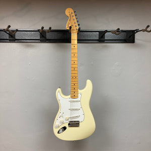 Fender Artist Series Jimi Hendrix Tribute Stratocaster USA 1997 w/Case on display, showcasing its pristine condition with original protective plastic on the pickguard.