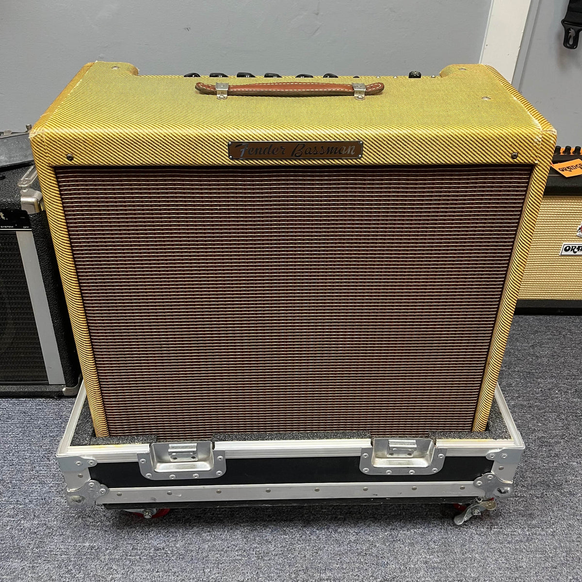 A 1957 Fender Bassman 5F6 Narrow Panel 40-Watt 4x10" Guitar Combo w/Flight Case sits on a gray carpeted floor.