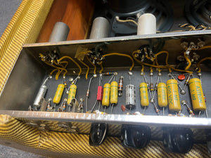 Close-up of vintage electronics and wiring inside a metal chassis, likely from a 1957 Fender Bassman 5F6 Narrow Panel 40-Watt 4x10" Guitar Combo with Flight Case.