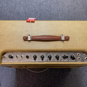 Top view of a 1957 Fender Bassman 5F6 Narrow Panel 40-Watt 4x10" Guitar Combo with brown handle, control knobs, switches, and a red “SOLD” tag on gray carpet. Includes flight case.