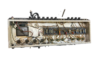 The interior of the 1966 Fender Black Panel Twin Reverb 2-Channel 85-Watt 2x12" Guitar Combo Amp w/Case reveals exposed wiring, circuit components, and control knobs on a metal chassis—classic Fender features.