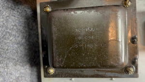Close-up of a metallic component from a 1966 Fender Black Panel Twin Reverb 2-Channel 85-Watt 2x12" Guitar Combo Amp, showing screws and stamped numbers: "022756," "606934," and "CSA11657.
