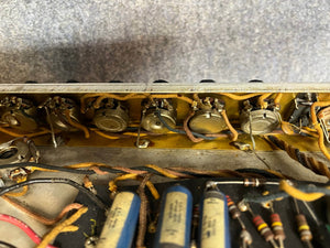 Close-up of electronic components—potentiometers, wires, and resistors—inside a 1966 Fender Black Panel Twin Reverb 2-Channel 85-Watt 2x12" Guitar Combo Amp, famous for its lush spring reverb.