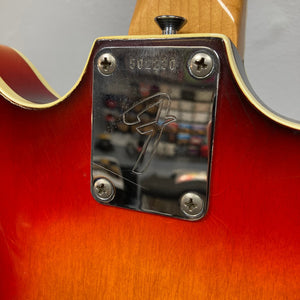 Fender Coronado II 1973 Sunburst guitar close-up, showcasing semi-hollowbody design, dual Fideli'Tron humbuckers, and sleek C-shaped neck. Visible metal screws and minor finish blemishes.