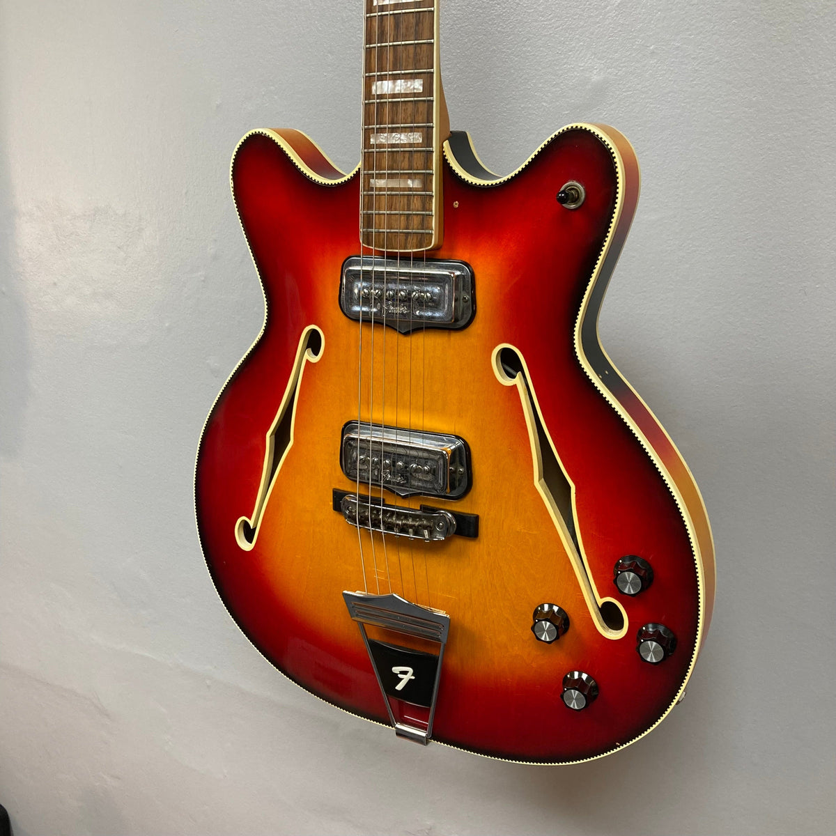 Fender Coronado II 1973 Sunburst semi-hollowbody guitar with dual Fideli&#39;Tron humbuckers, shown close-up with visible finish blemishes and minor fret wear.