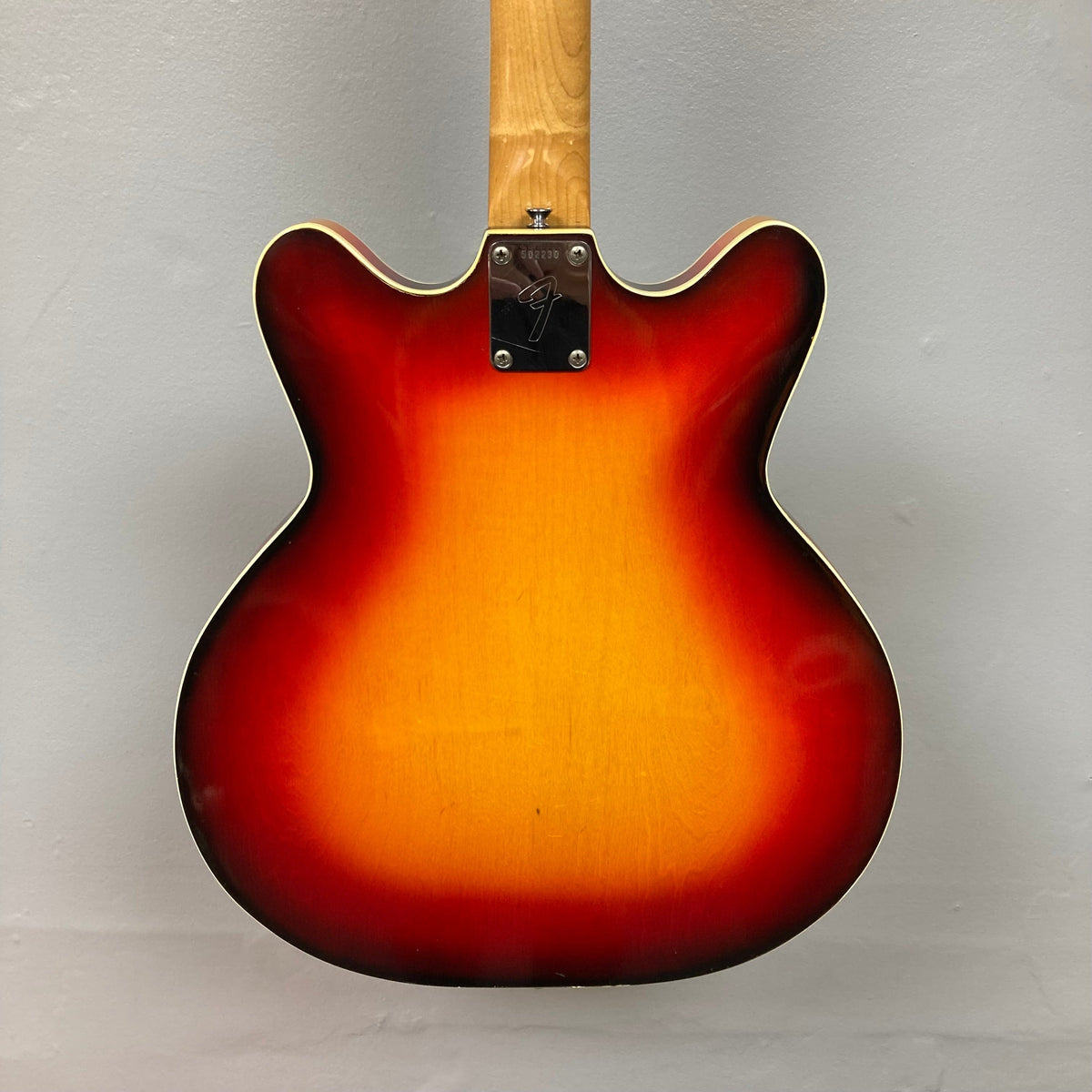 Close-up of a Fender Coronado II 1973 Sunburst guitar, highlighting its semi-hollowbody design, dual Fideli&#39;Tron humbuckers, and bound top.