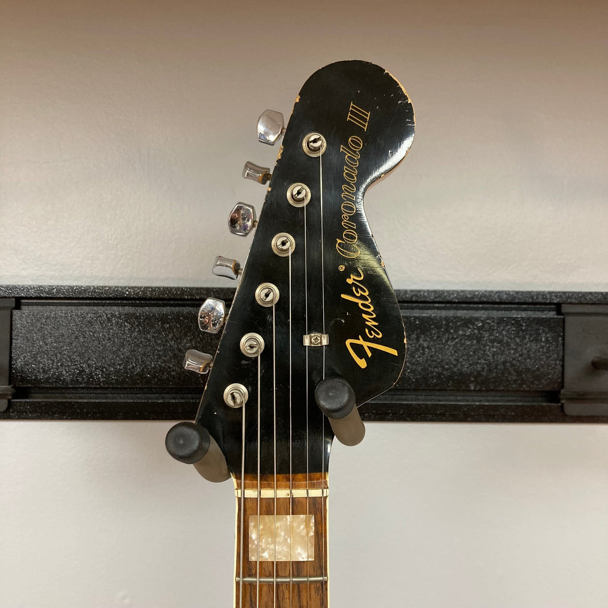 Fender Coronado II 1973 Sunburst on a stand with visible semi-hollow body, dual humbuckers, and minor finish blemishes.