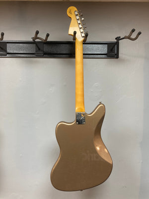 Fender Custom Shop Jaguar Journeyman guitar mounted on a wall, highlighting its intricate craftsmanship and vintage relic finish.