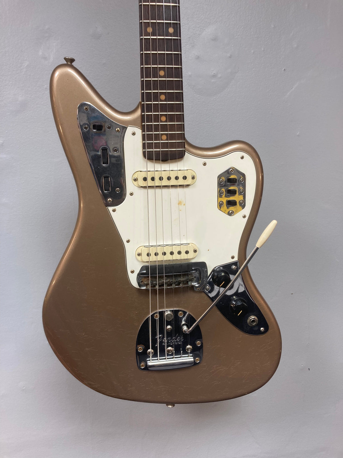 Fender Custom Shop Jaguar Journeyman electric guitar with white trim, close-up of strings and neck, showcasing vintage relic craftsmanship.