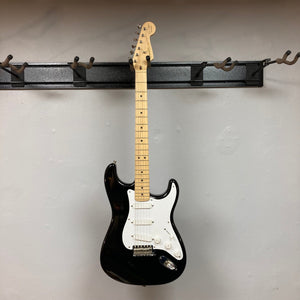 Fender Eric Clapton Artist Series Stratocaster USA 2001 electric guitar, pristine condition, displayed on a wall, includes original case.