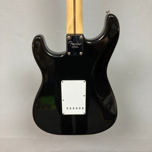 Fender Eric Clapton Artist Series Stratocaster USA 2001 with a black body, wooden handle, and original case.