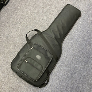 A black soft gigbag, ideal for the Fender Heritage '60s Telecaster Custom Made in Japan Sunburst, sits on a gray carpet and features a front zipper pocket.