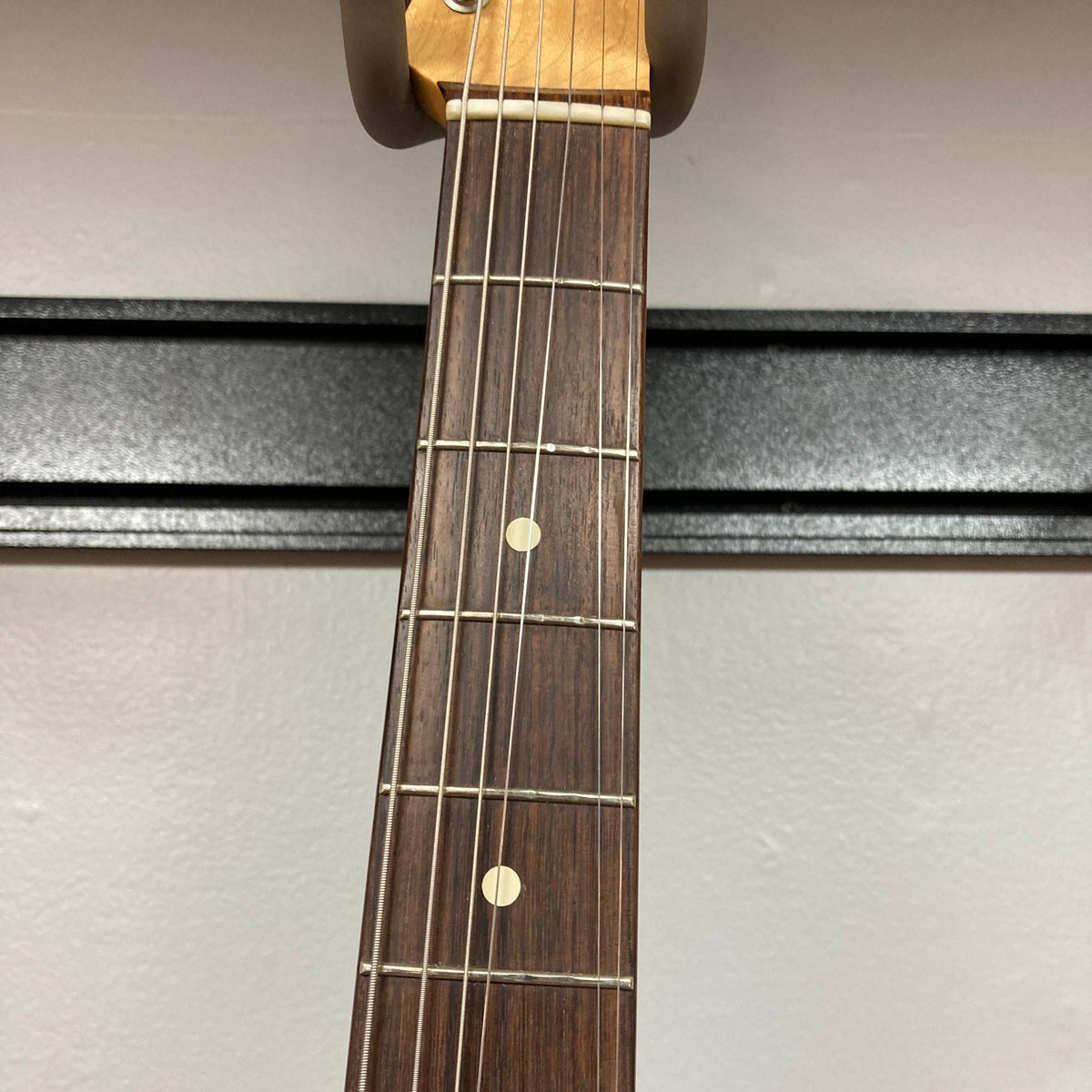 Close-up of the Fender Heritage '60s Telecaster Custom Made in Japan Sunburst w/Gigbag, showing six strings, frets, and two dot inlays on its rosewood fingerboard against a plain background.