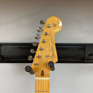 Fender Japan Stratocaster Candy Apple Red 2004 guitar neck and pegs, displayed on a wall, with close-up details of the tuning pegs.