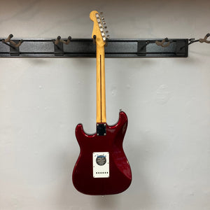 Fender Japan Stratocaster Candy Apple Red 2004, electric guitar on a hook, includes original case.