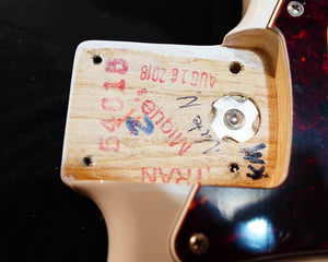 Close-up of a Fender Limited Edition Ash American Professional Stratocaster White Blonde guitar neck pocket showing wood grain, screws, metal insert, serial numbers, manufacturer marks, and handwritten notes.