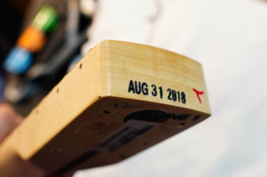 Close-up of the bottom of a Fender Limited Edition Ash American Professional Stratocaster White Blonde neck, stamped "AUG 31 2018" with a small red mark beside the date.