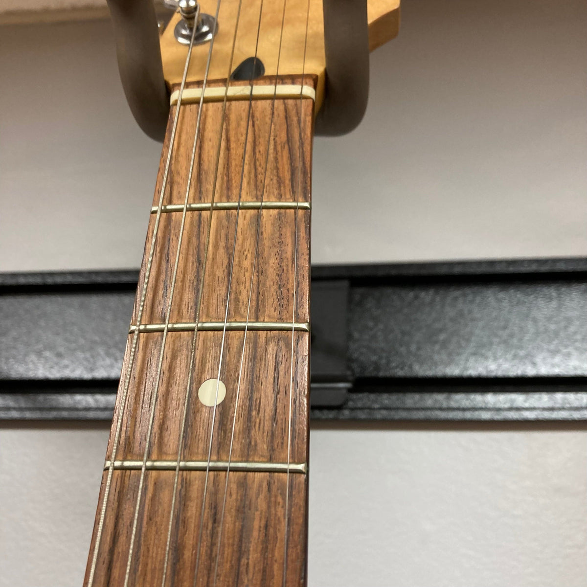 Fender MIM Stratocaster Blue 1998 with visible strings and pickups, showcasing a well-used guitar neck with minor blemishes.