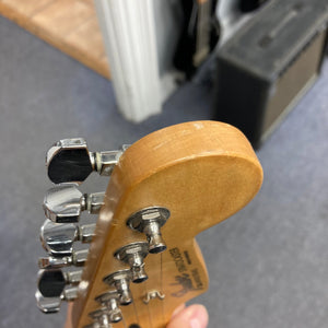 Fender MIM Stratocaster Blue 1998, well-used, held in hand, showcasing its classic design and versatile pickups. Includes case.