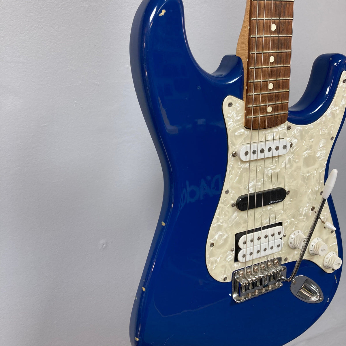 Fender MIM Stratocaster Blue 1998 on stand, showcasing its iconic design and versatile pickups.